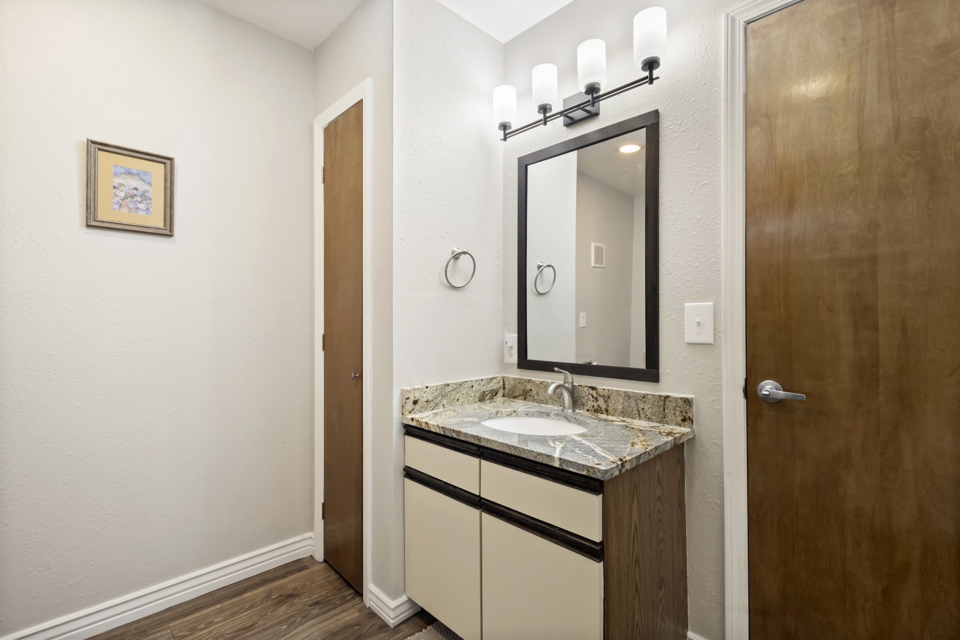 Main level king bedroom ensuite bathroom with granite countertops and tub/shower combo.