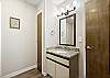 Main level king bedroom ensuite bathroom with granite countertops and tub/shower combo. 