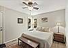 Main level king bedroom with Smart TV, ensuite bathroom and back patio access. 