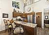 Fully equipped galley kitchen with stainless steel appliances and granite countertops.