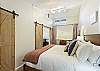 King bedroom with ensuite bathroom open to the lower level. 