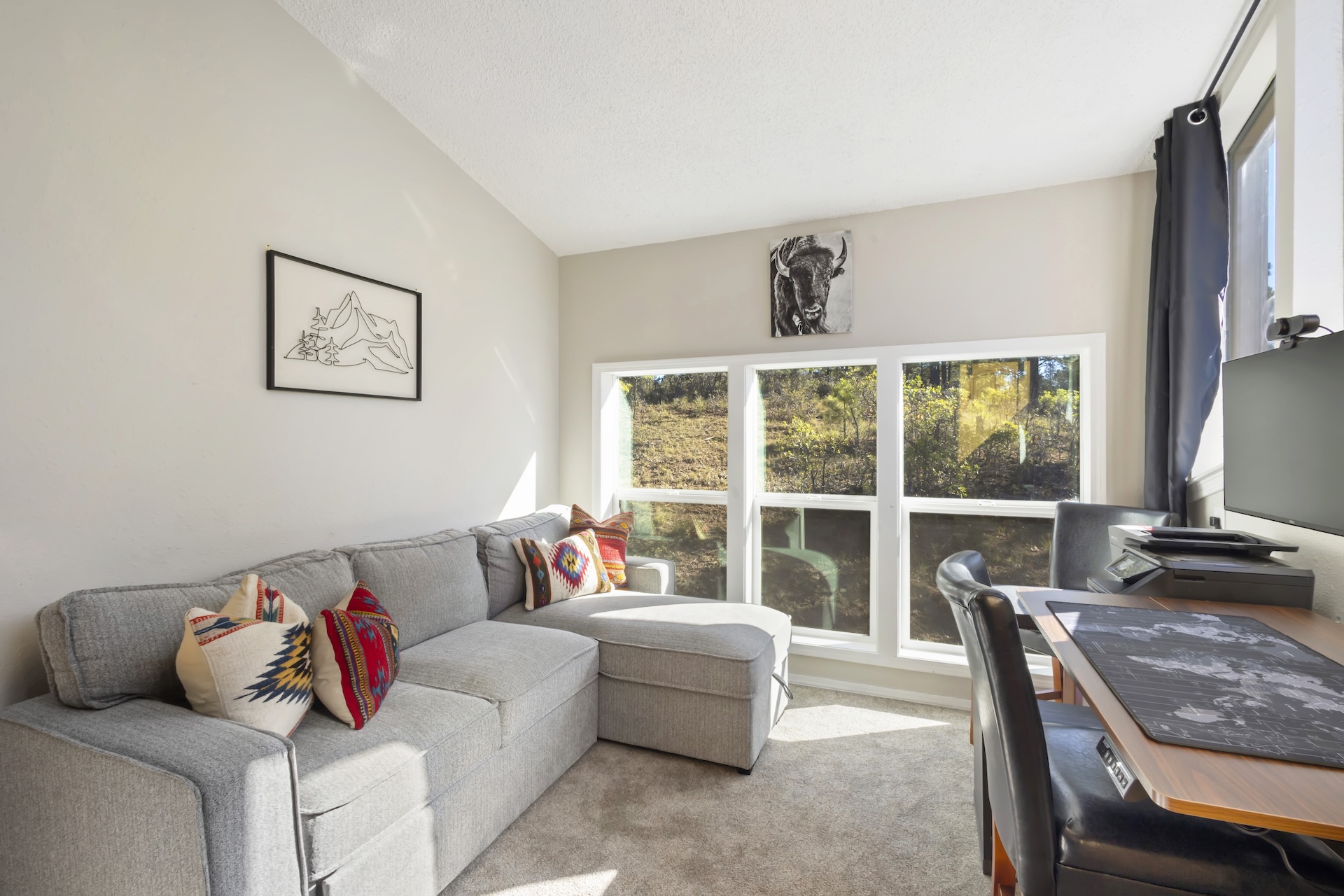 Bright office space with monitor and printer. Perfect for remote work.