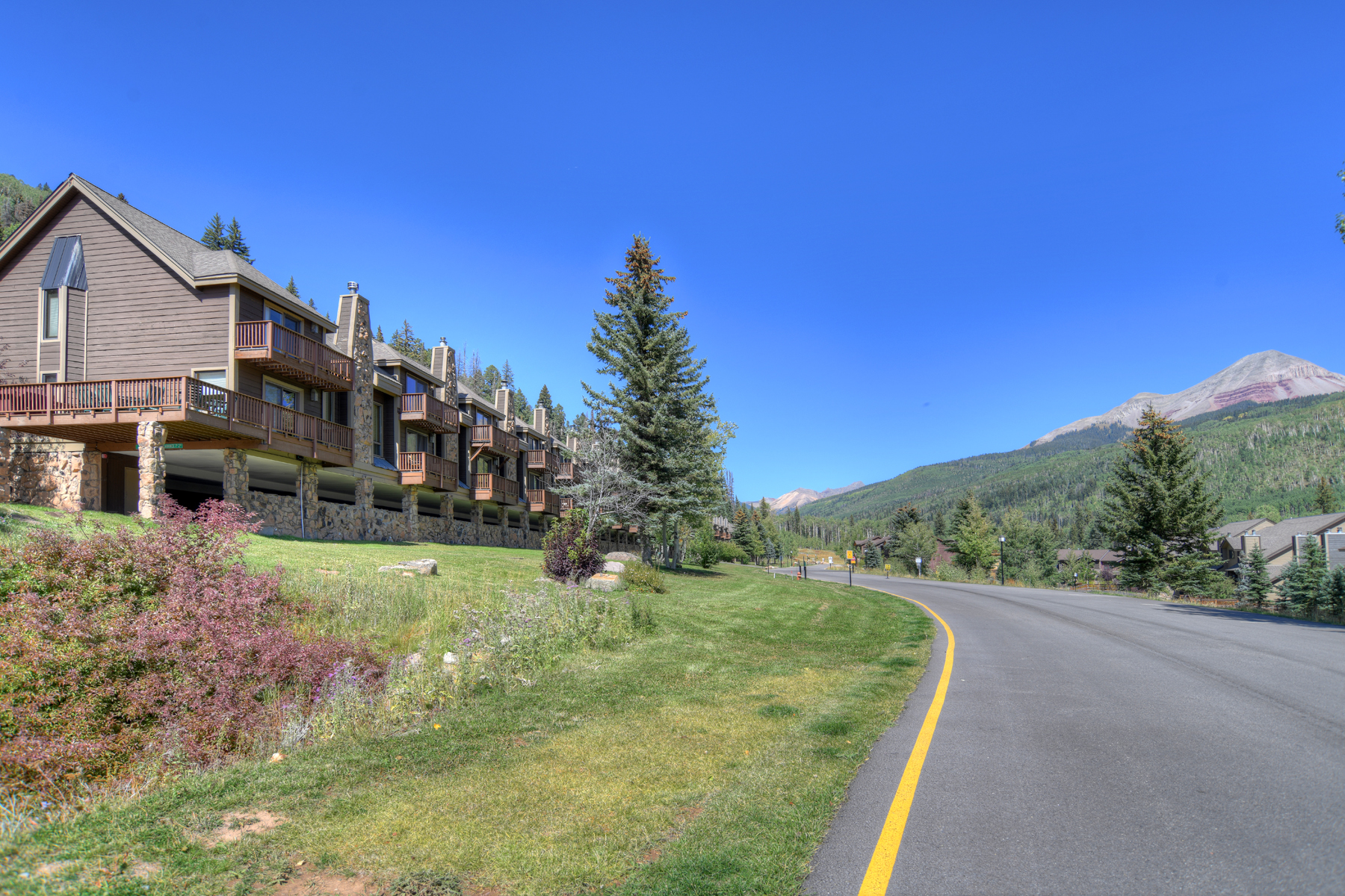 Exterior view of the condo building with Engineer Mountain in the background