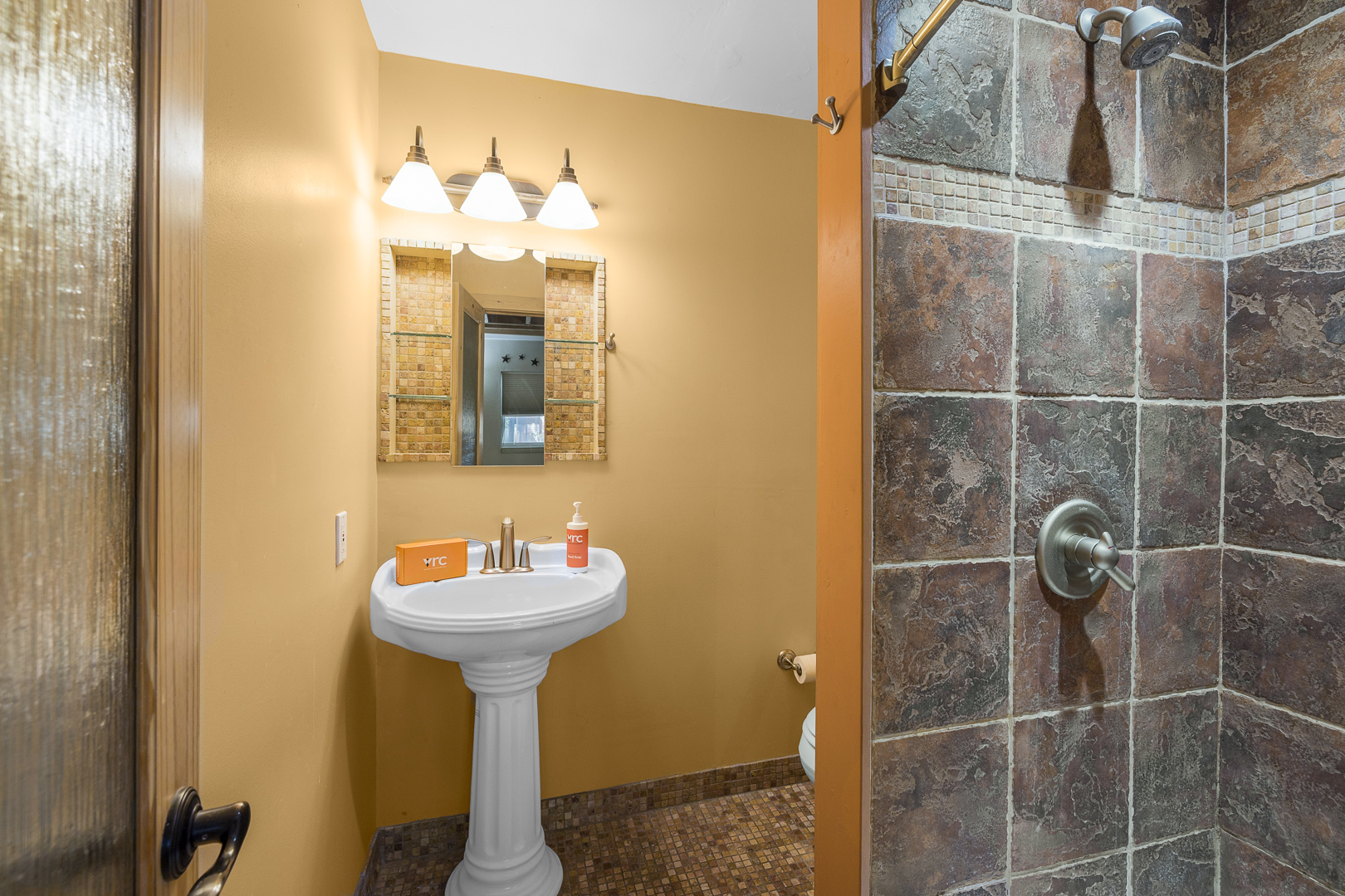Full bathroom #1 featuring a sleek walk-in shower.
