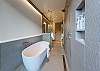 soaking tub and wet room attached to the downstairs king room