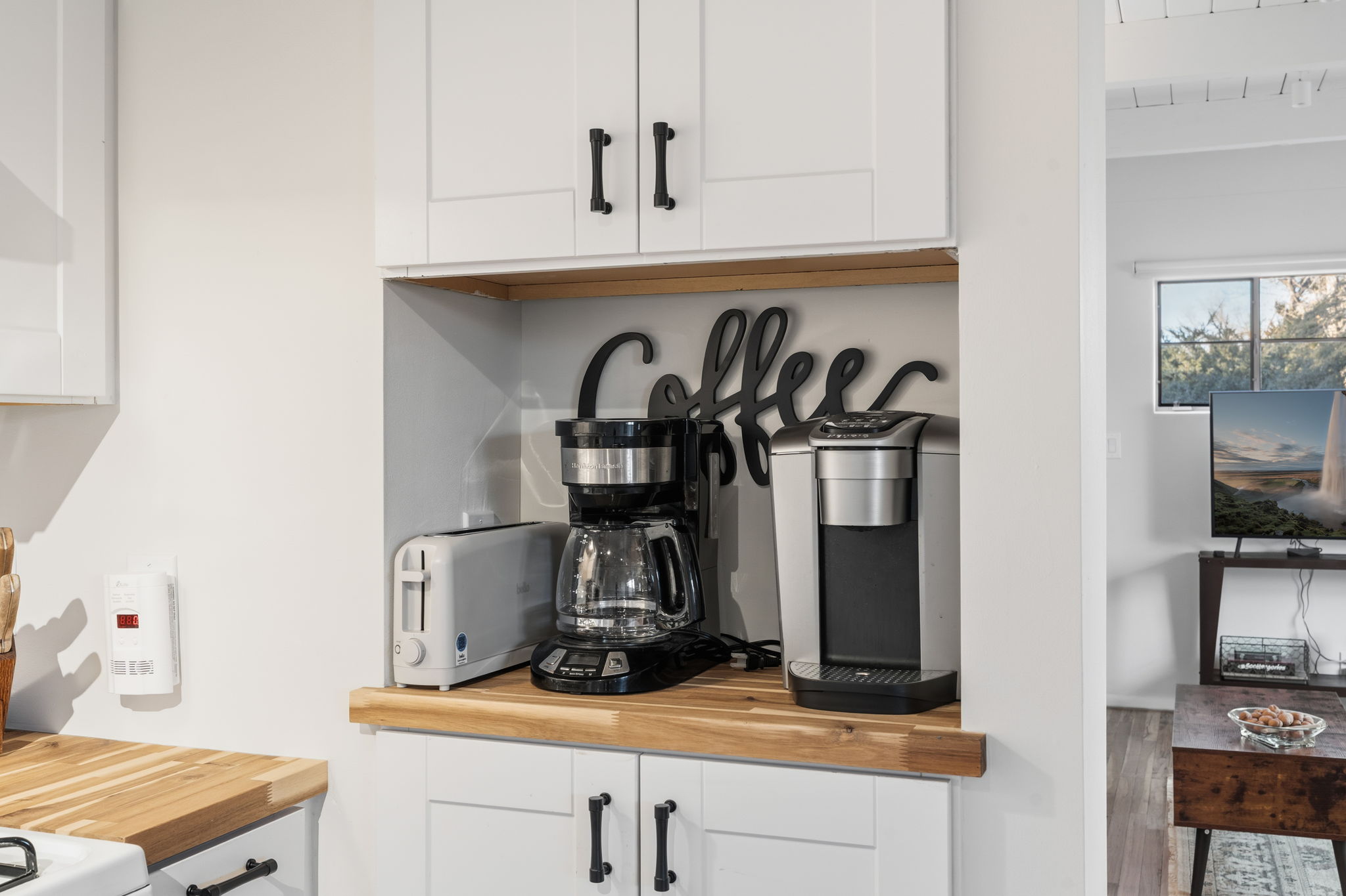 Modern kitchen with sleek white cabinetry and everything you need to cook delicious meals
