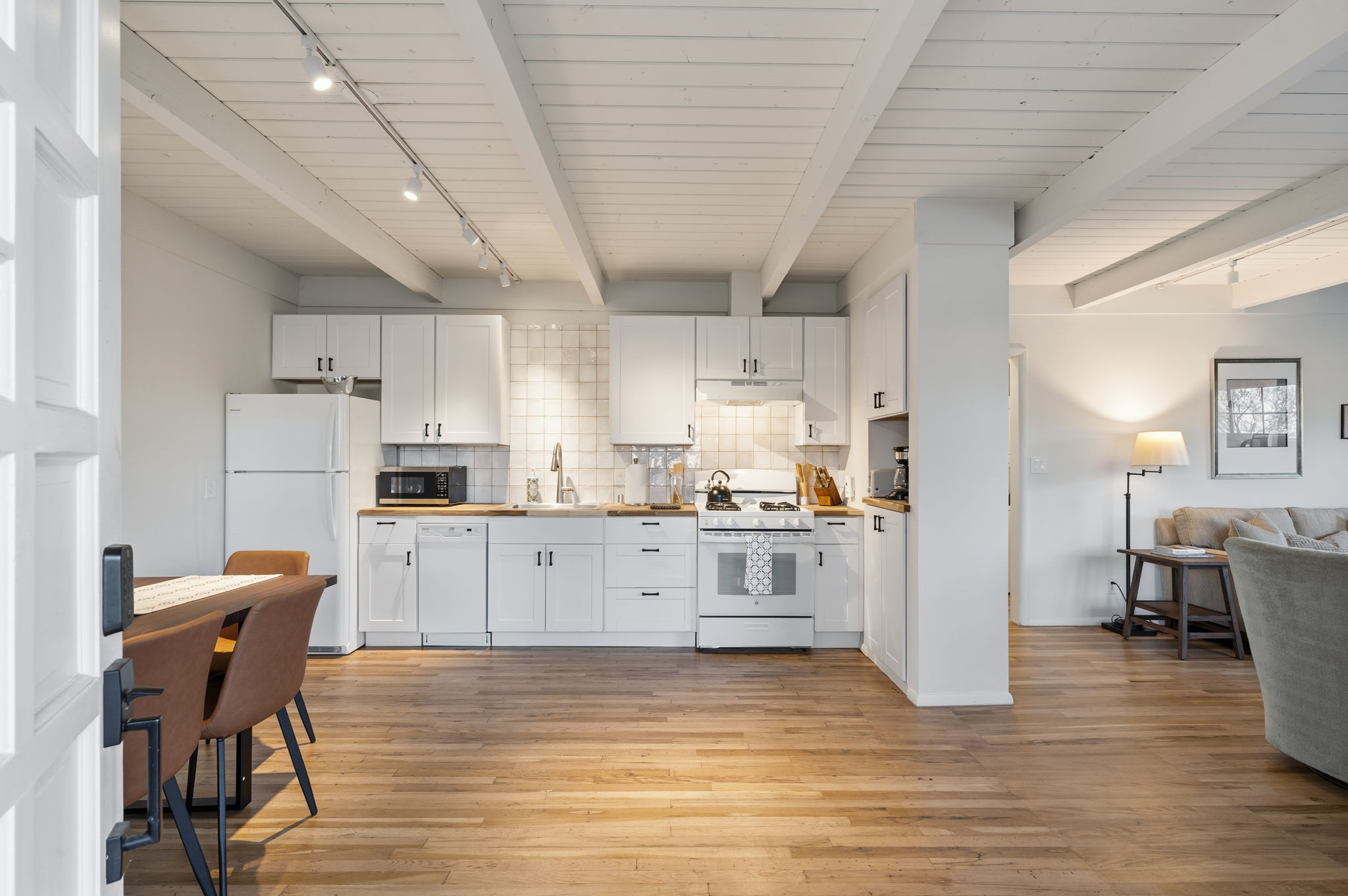 Open-concept living area with contemporary furnishings and warm Santa Fe character