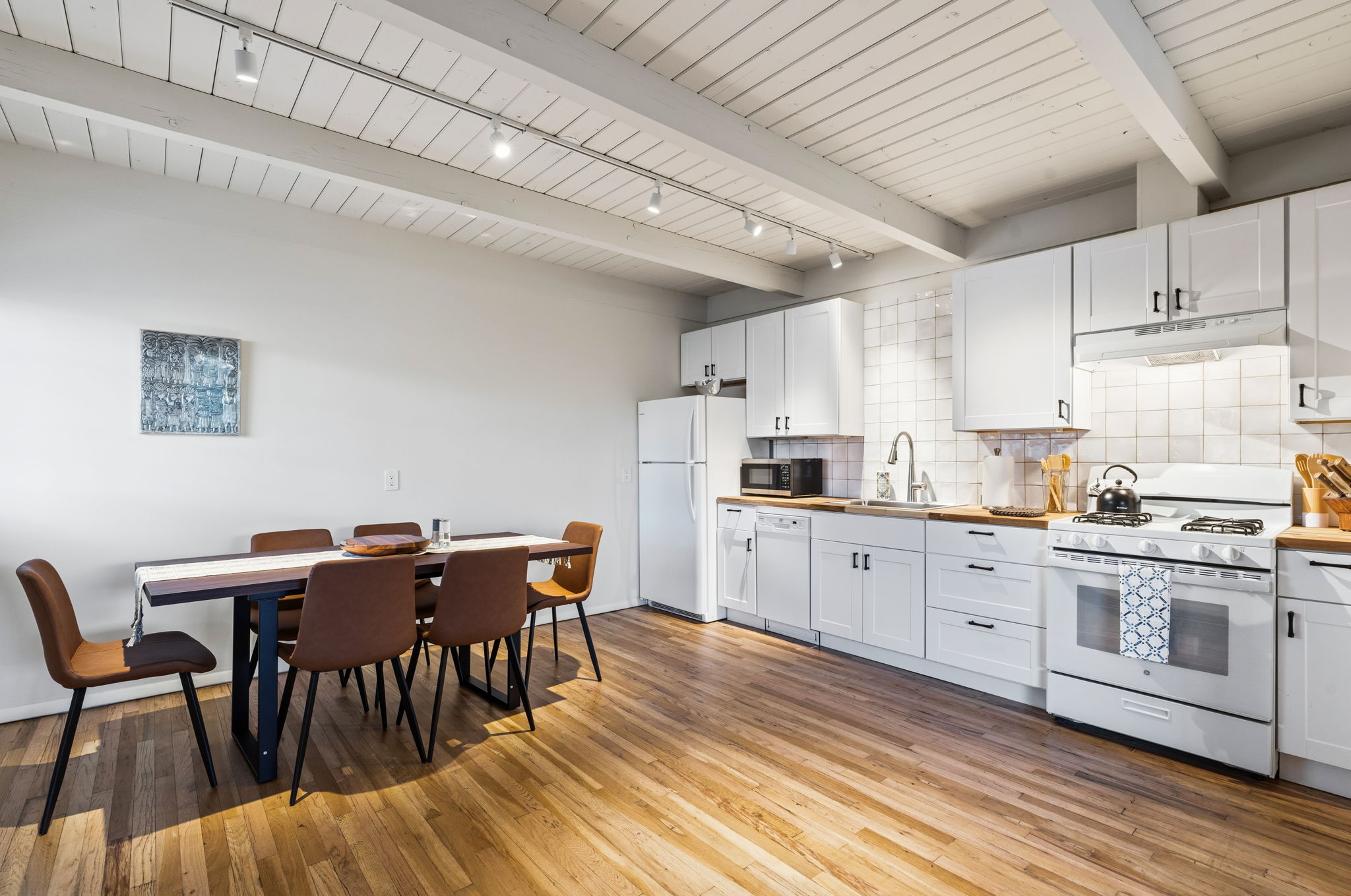 Dining table seats six comfortably with stylish modern finishes and abundant natural light