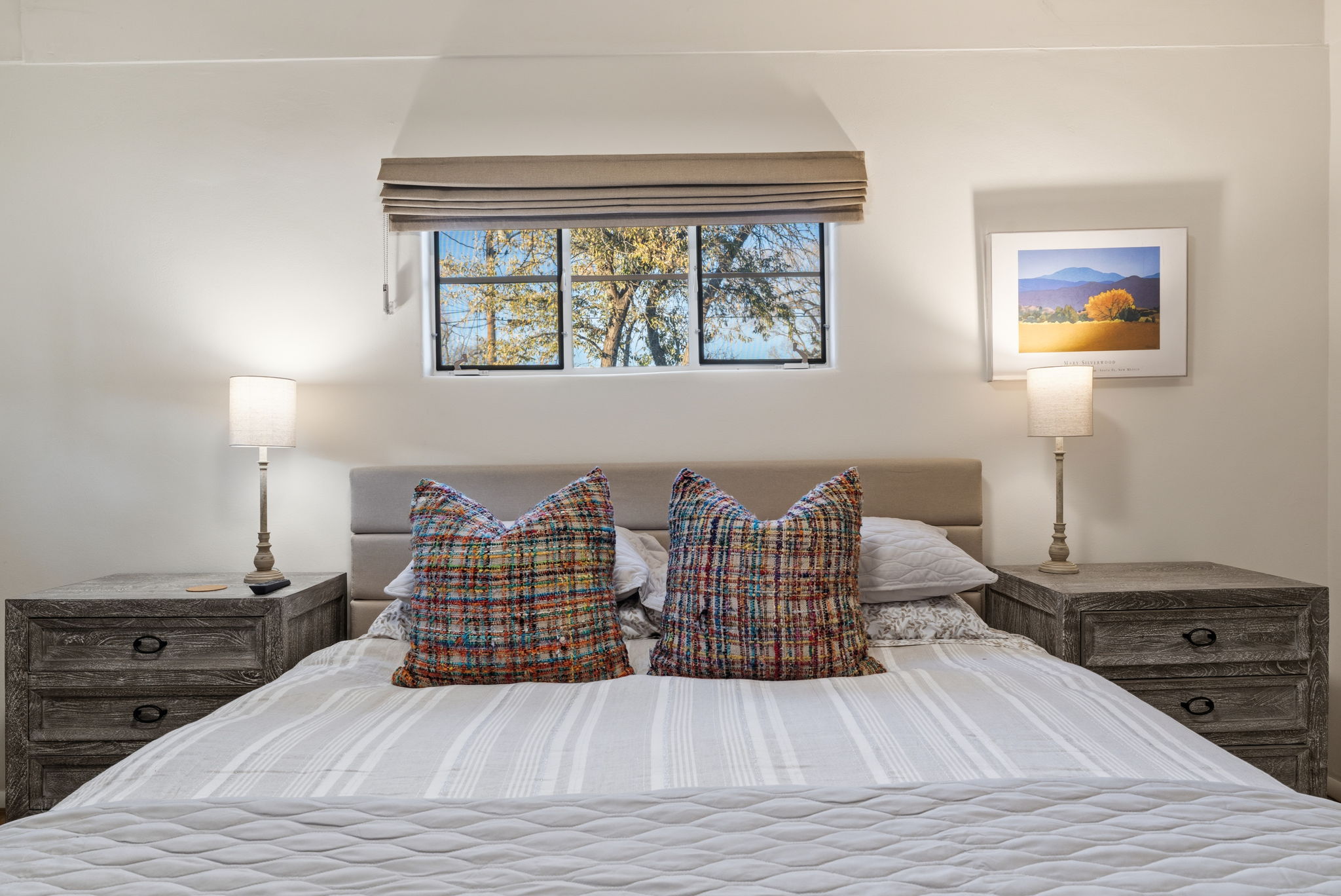 Comfortable queen bed with plush bedding and contemporary mountain-modern style