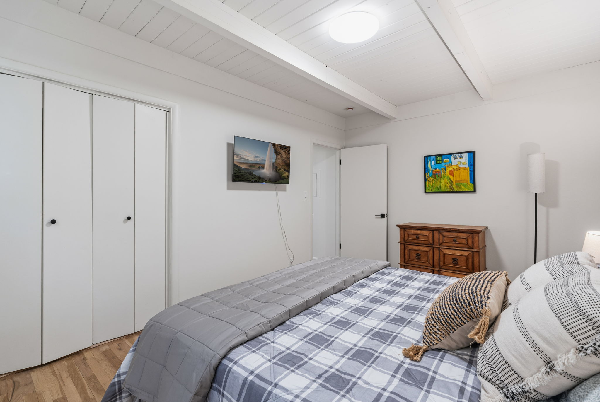 Spacious queen bedroom with warm tones and thoughtful modern updates