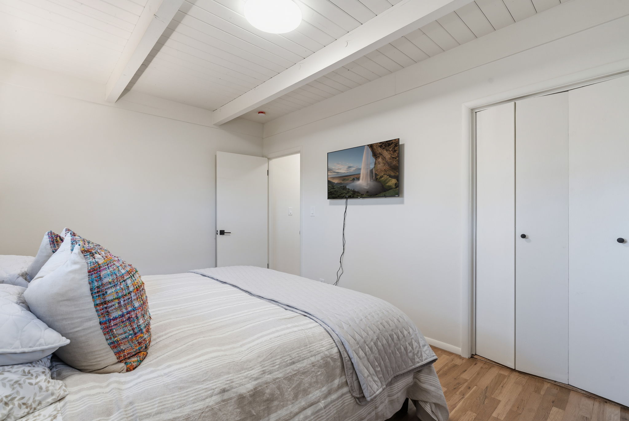 Serene queen bedroom with Smart TV and modern finishes—your peaceful Santa Fe retreat
