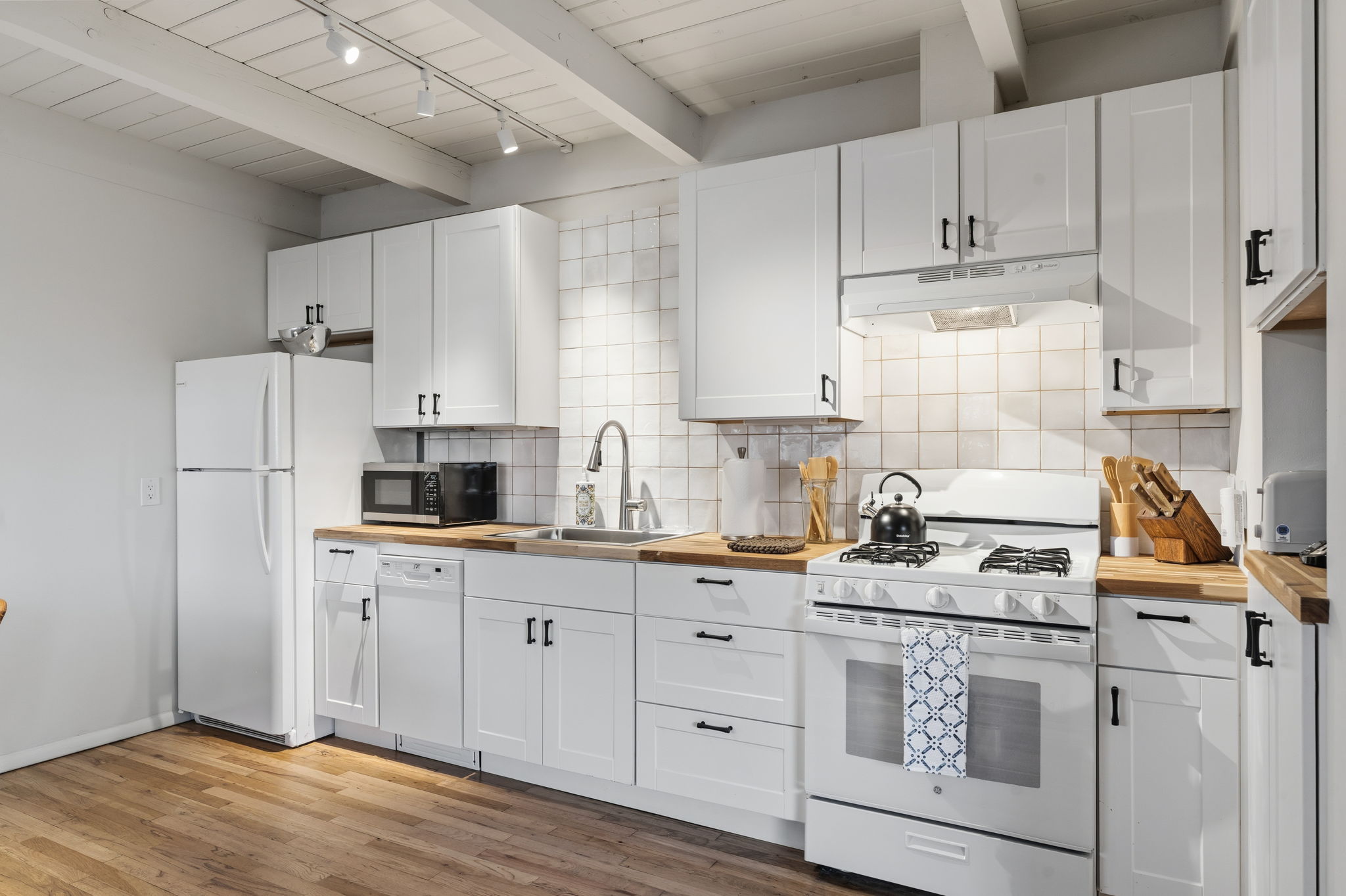 Open shelving and contemporary design make this kitchen as functional as it is beautiful