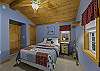 Queen bedroom with overhead fan located on the main level