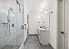 Full bathroom featuring a sleek walk-in shower.
