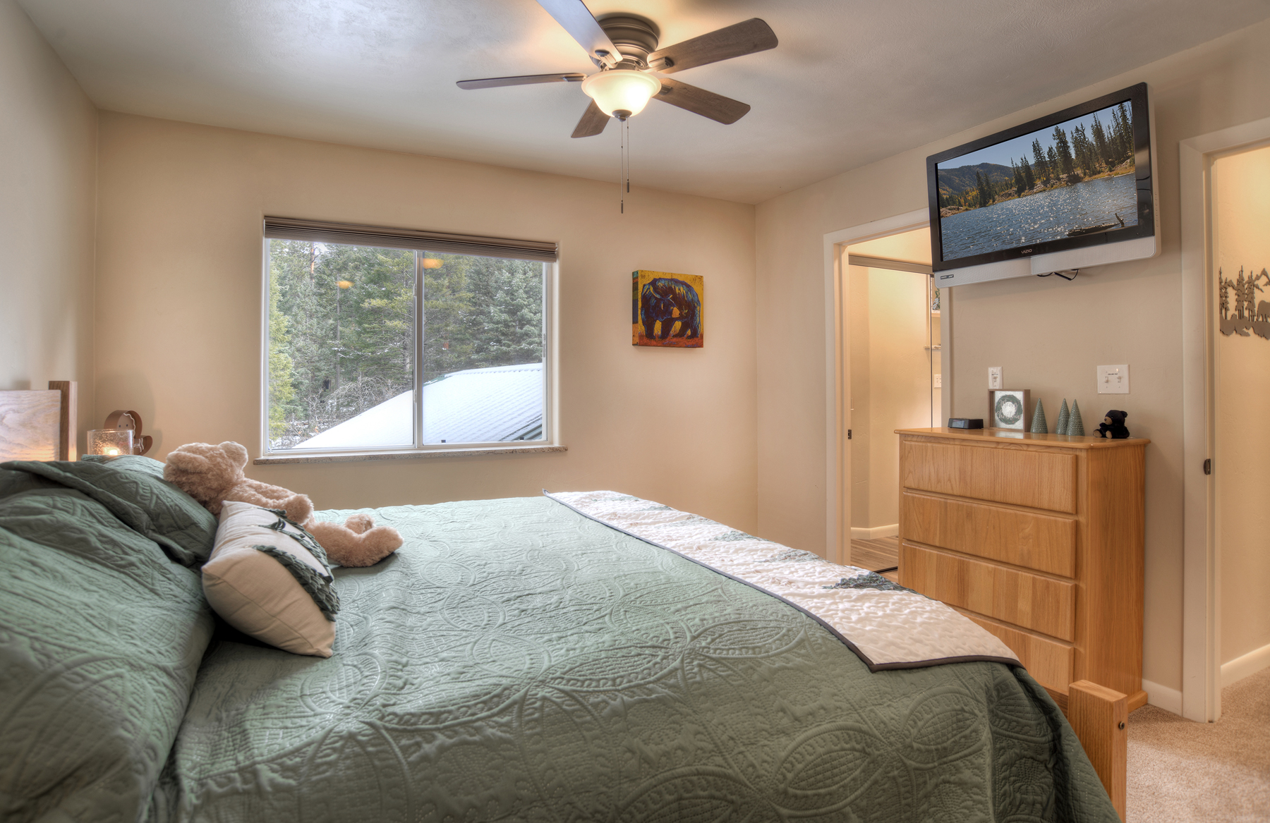 Comfortable guest bedroom with natural light and views. Part of Bedroom 2 suite.