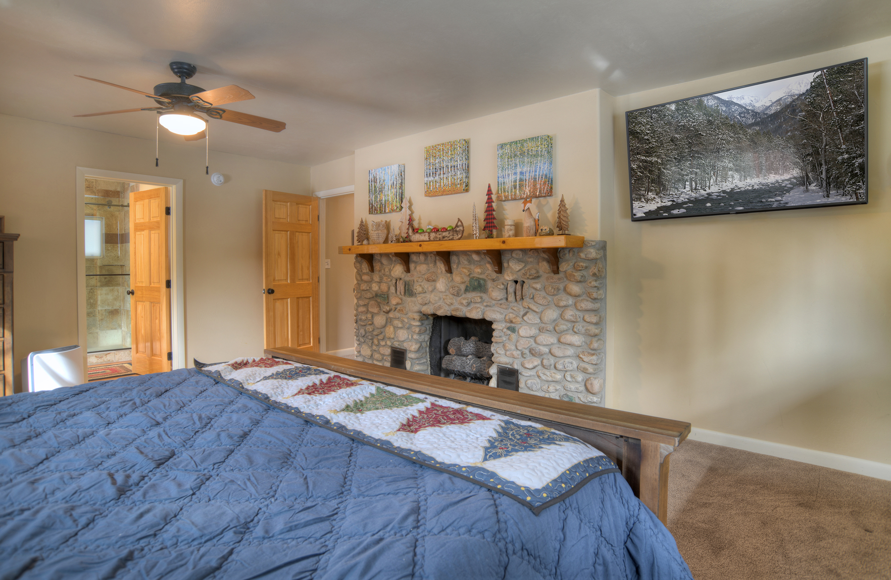 Master bedroom with king bed, fireplace, and ensuite bathroom. Smart TV for relaxation.