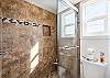 Fresh and functional full bathroom with a walk-in shower and contemporary design.
