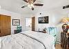 Queen bedroom #1 features an overhead fan and a Smart TV