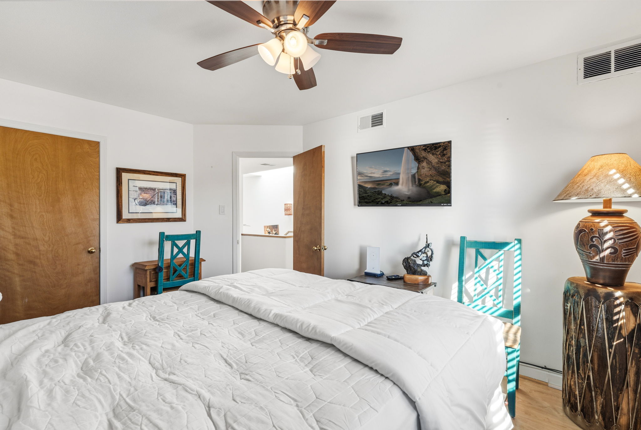 Queen bedroom #1 features an overhead fan and a Smart TV