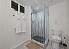Full bathroom featuring a sleek walk-in shower.

