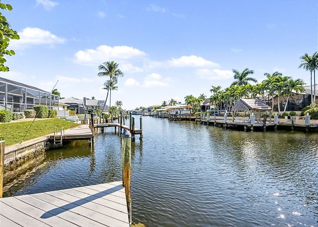 New Listing! Canalfront Comfort | Heated Pool, Patio & Palm-Lined Views