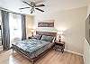 King bedroom #2 with an overhead fan and blackout curtains for a restful night's sleep.