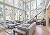 Step into the open-concept living room with floor to ceiling windows