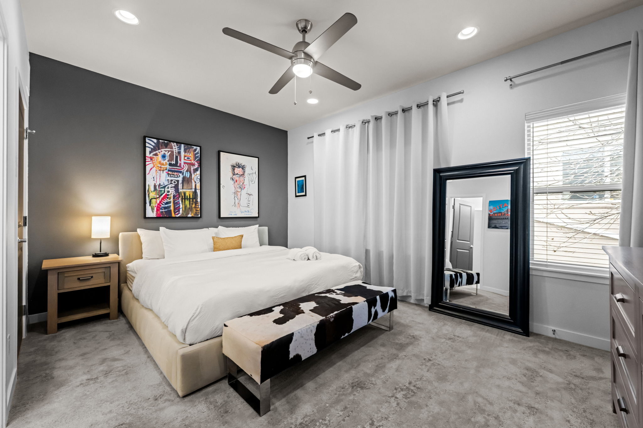 Comfortable queen bedroom with plush bedding and ensuite bath—sleep well in Denver