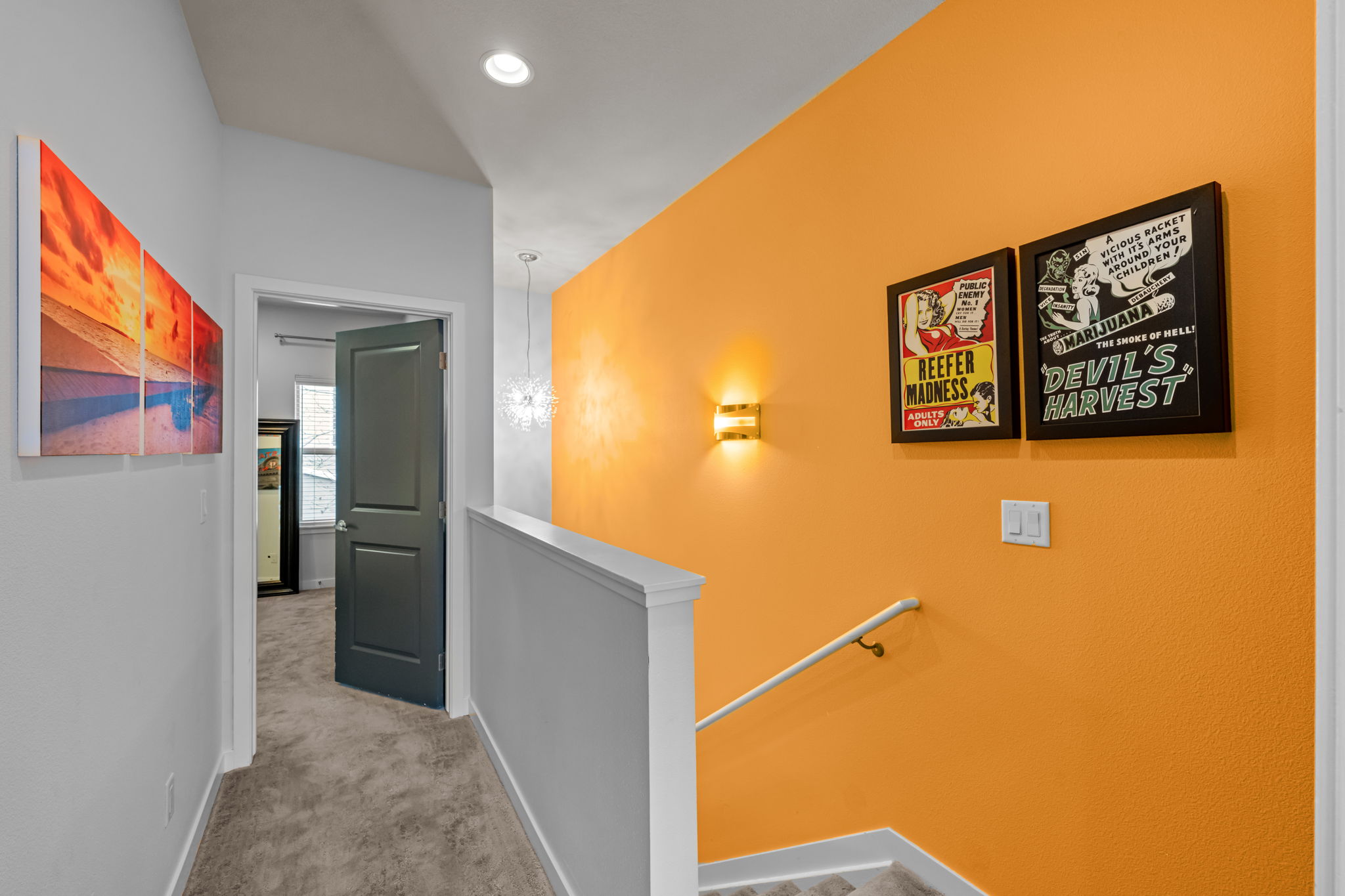 Bright interior hallway with vibrant accent wall and artwork