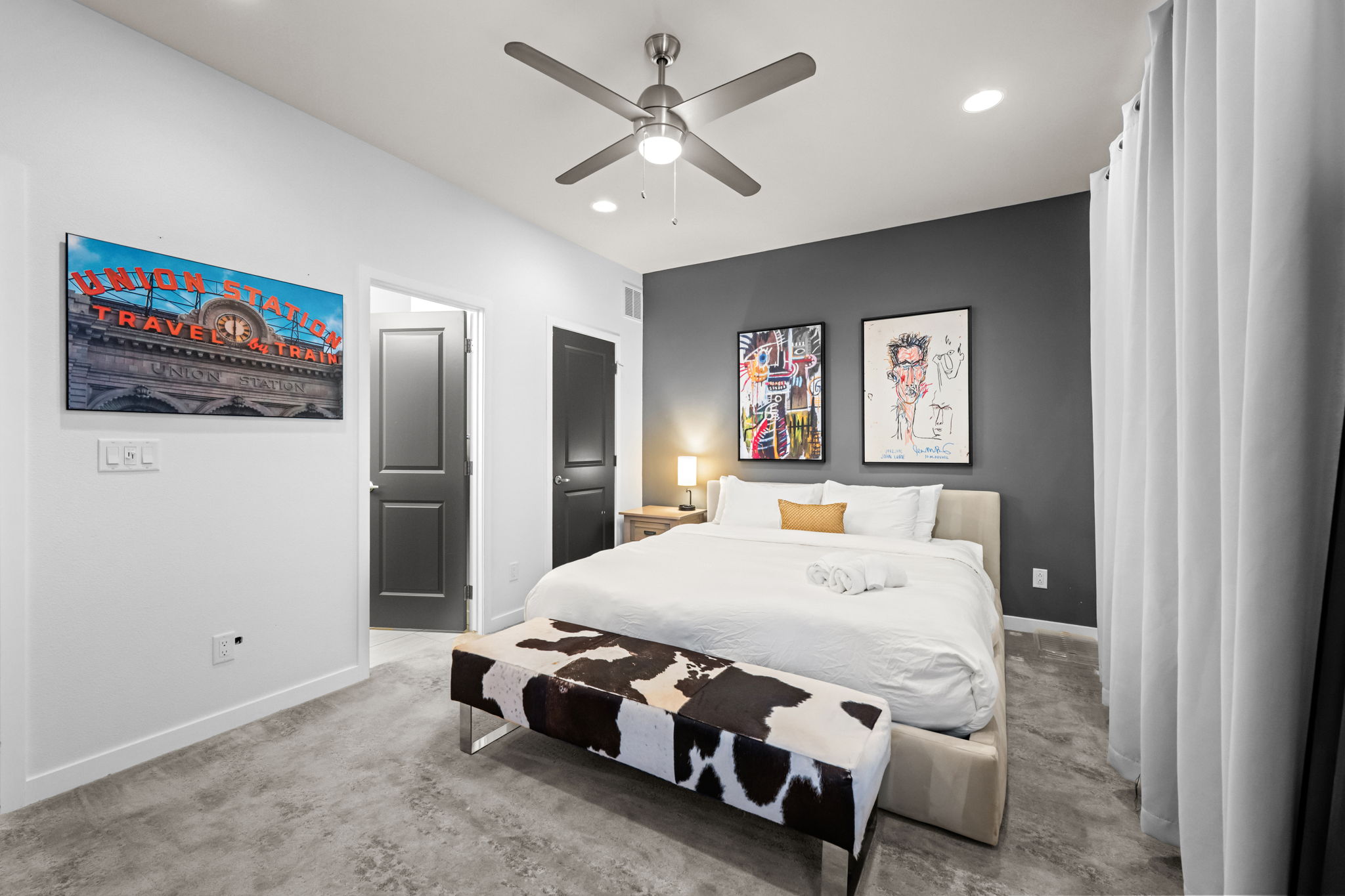 Queen bedroom with Smart TV and ensuite bathroom—one of three private ensuites in this home