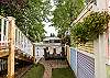 Side view of the inn showcasing deck access, backyard space, and mature trees.