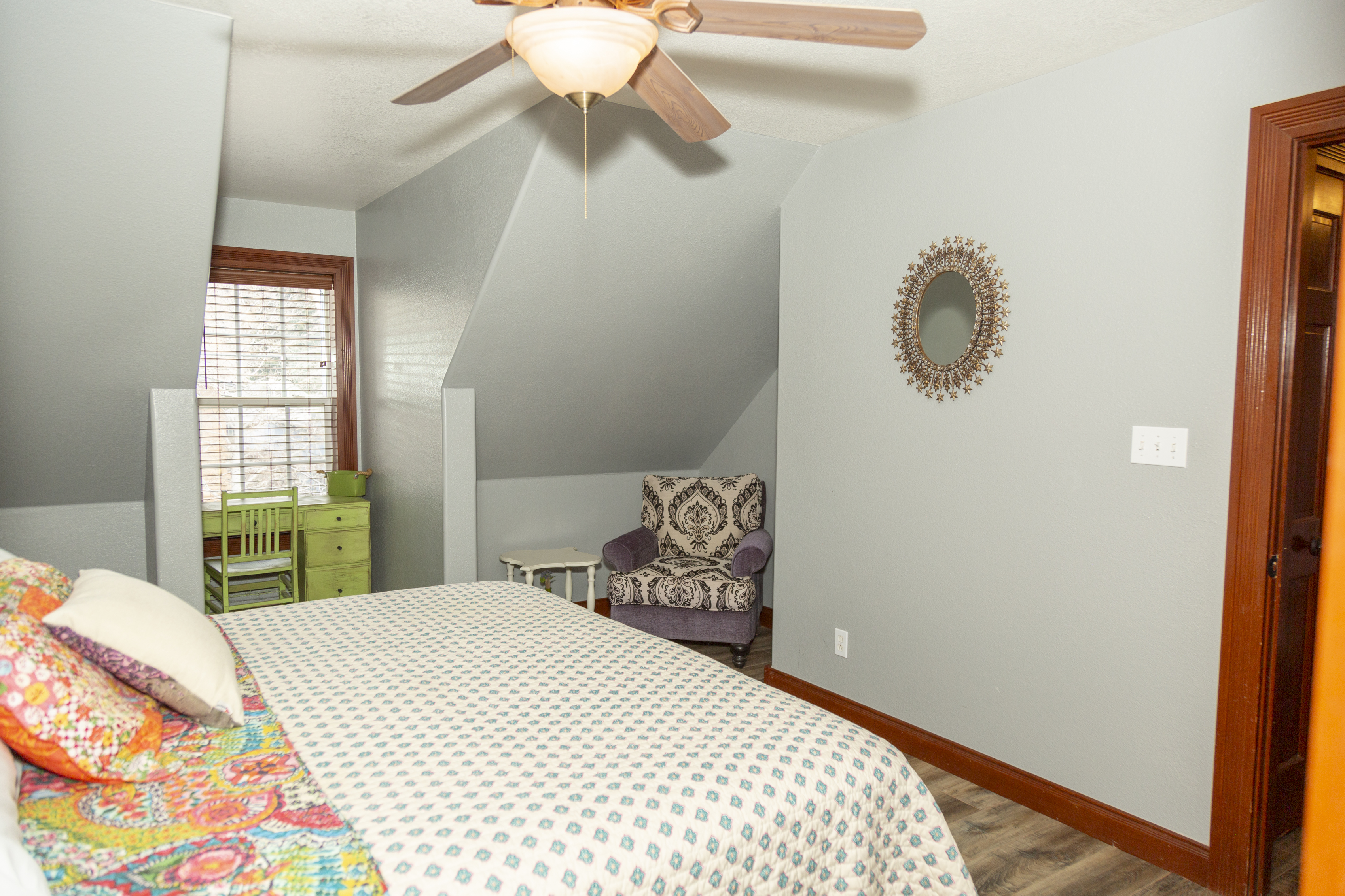 Bedroom with green accents, queen bed, and classic mountain-town feel.