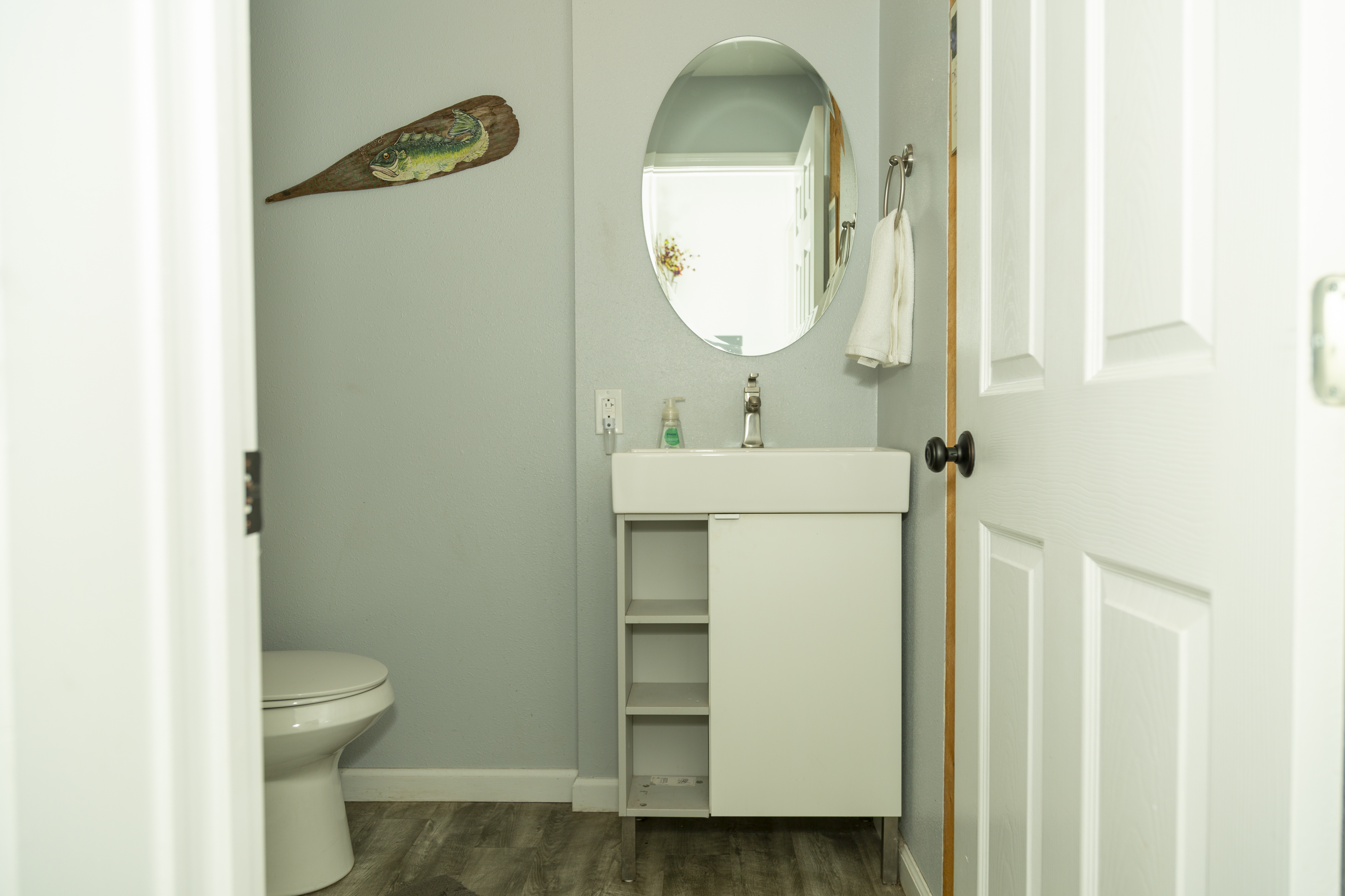 In-unit laundry area with washer, dryer, and ironing station in Roseview Perch.