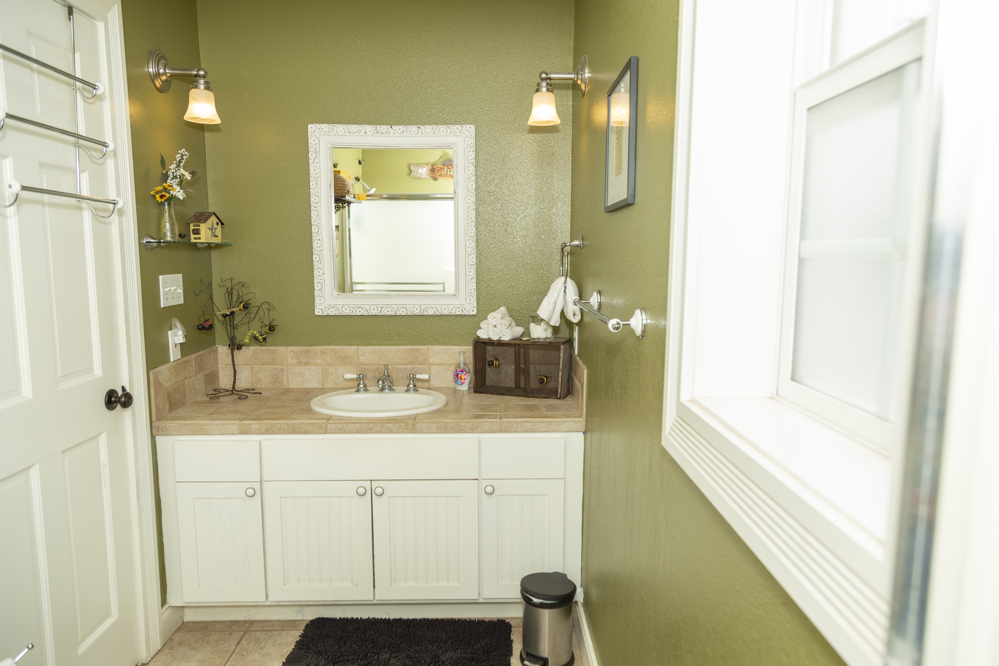 Clean bathroom with shower and updated finishes.Exterior staircase view highlighting access to second-story units with Victorian details.