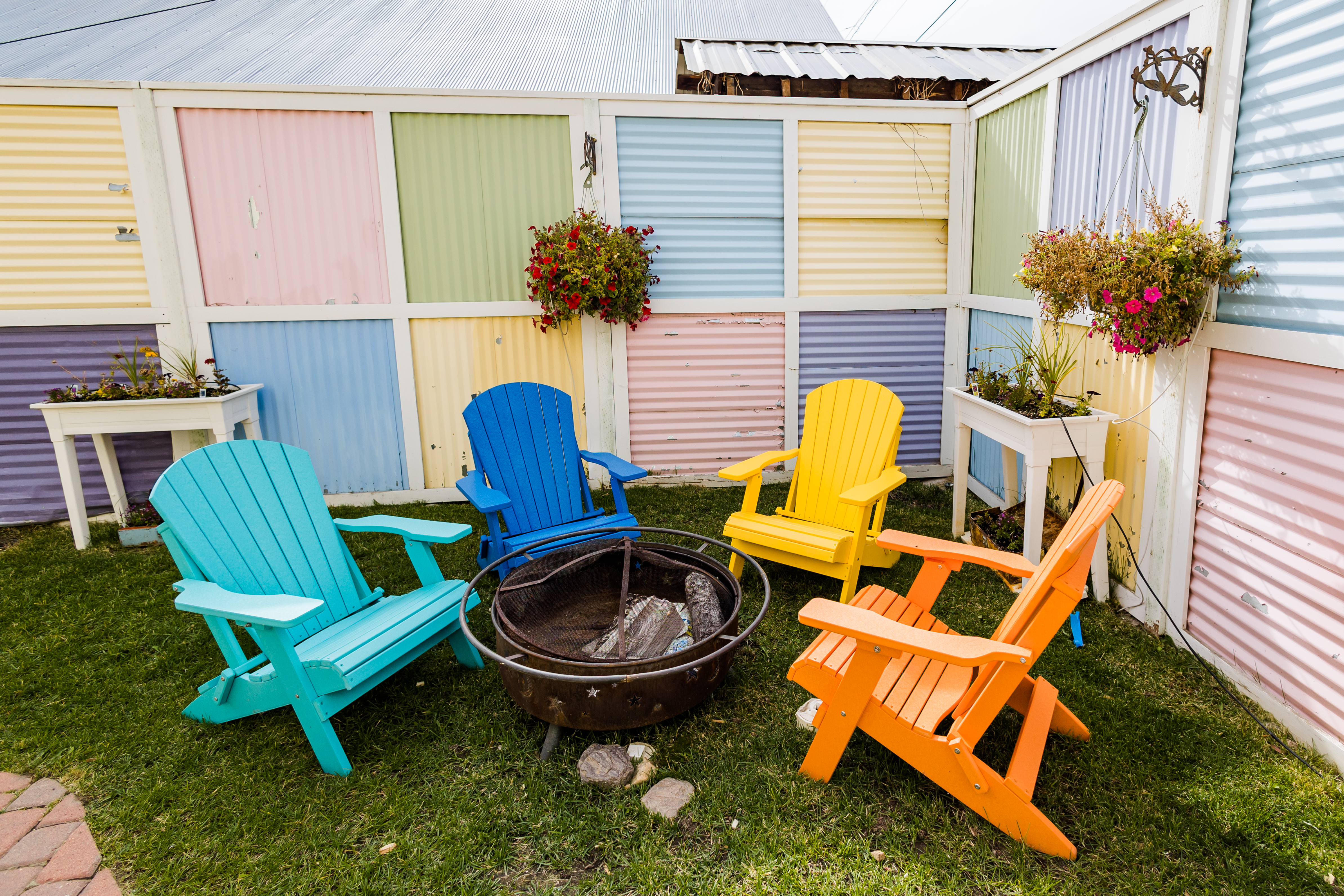 Large shared backyard with fire pit and colorful seating for evening conversations under Colorado stars.Close-up of decorative Victorian porch detailing.