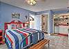 Rosewood Studio with a spacious sleeping and kitchen area.  Queen bed and efficiency kitchen, dining table for two and separate backdoor to courtyard. 