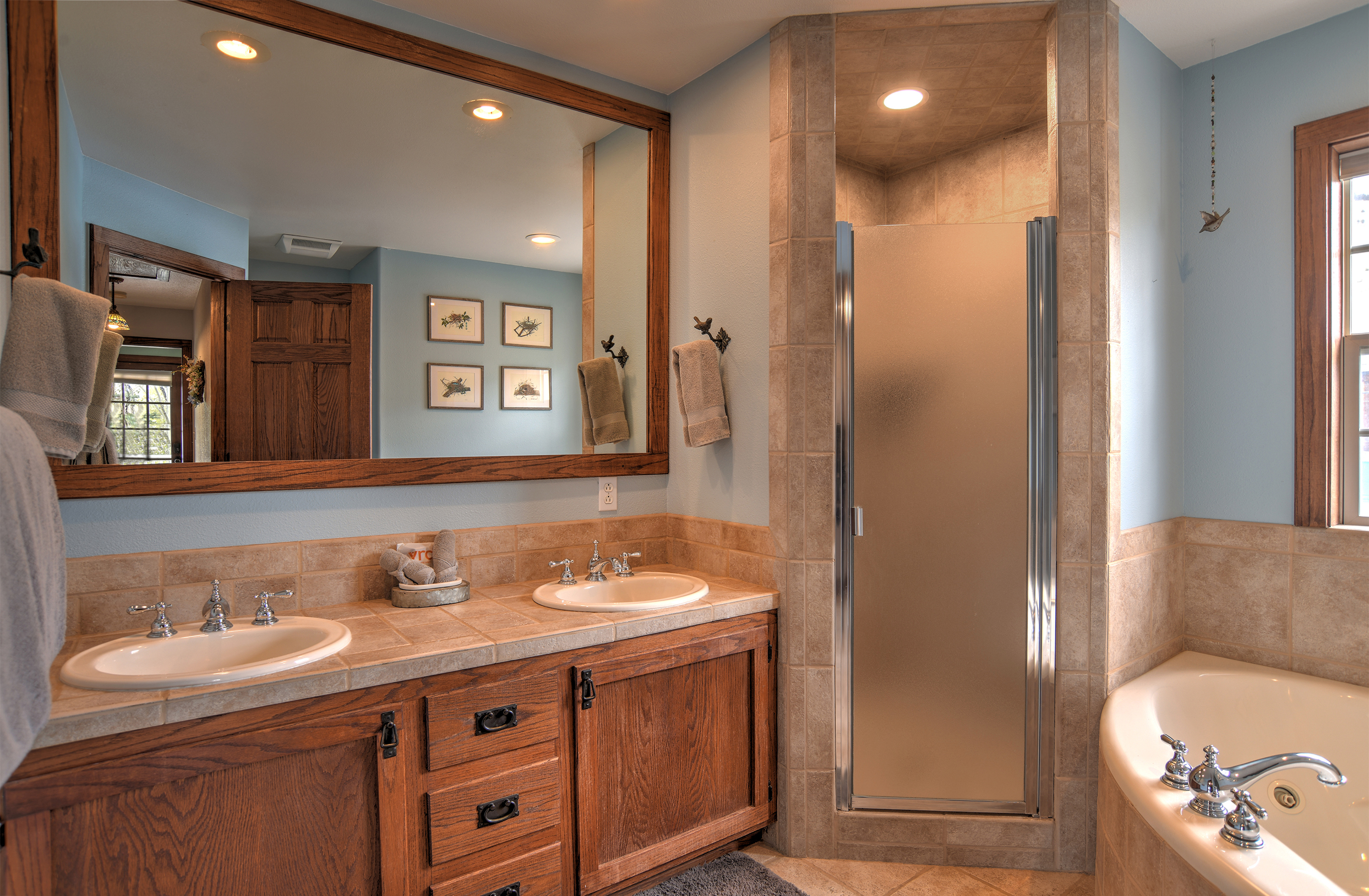Full bathroom with walk in shower and soaking tub.