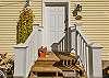 Front porch detail with Victorian trim and welcoming entry.