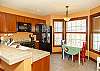 Fully equipped kitchen with breakfast bar and family-friendly dining area.