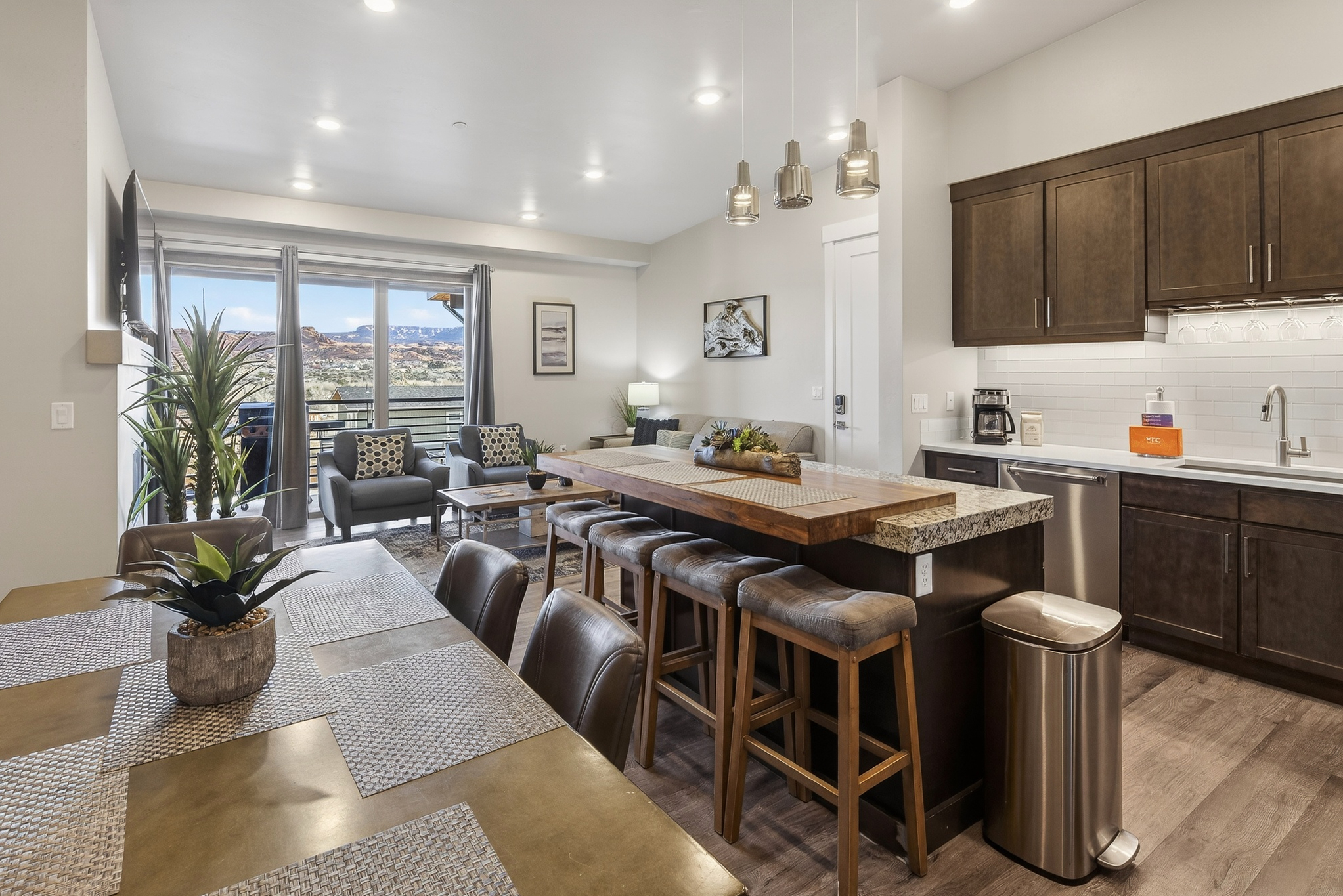Designer kitchen featuring quartz countertops, stainless steel appliances, and a sleek island.