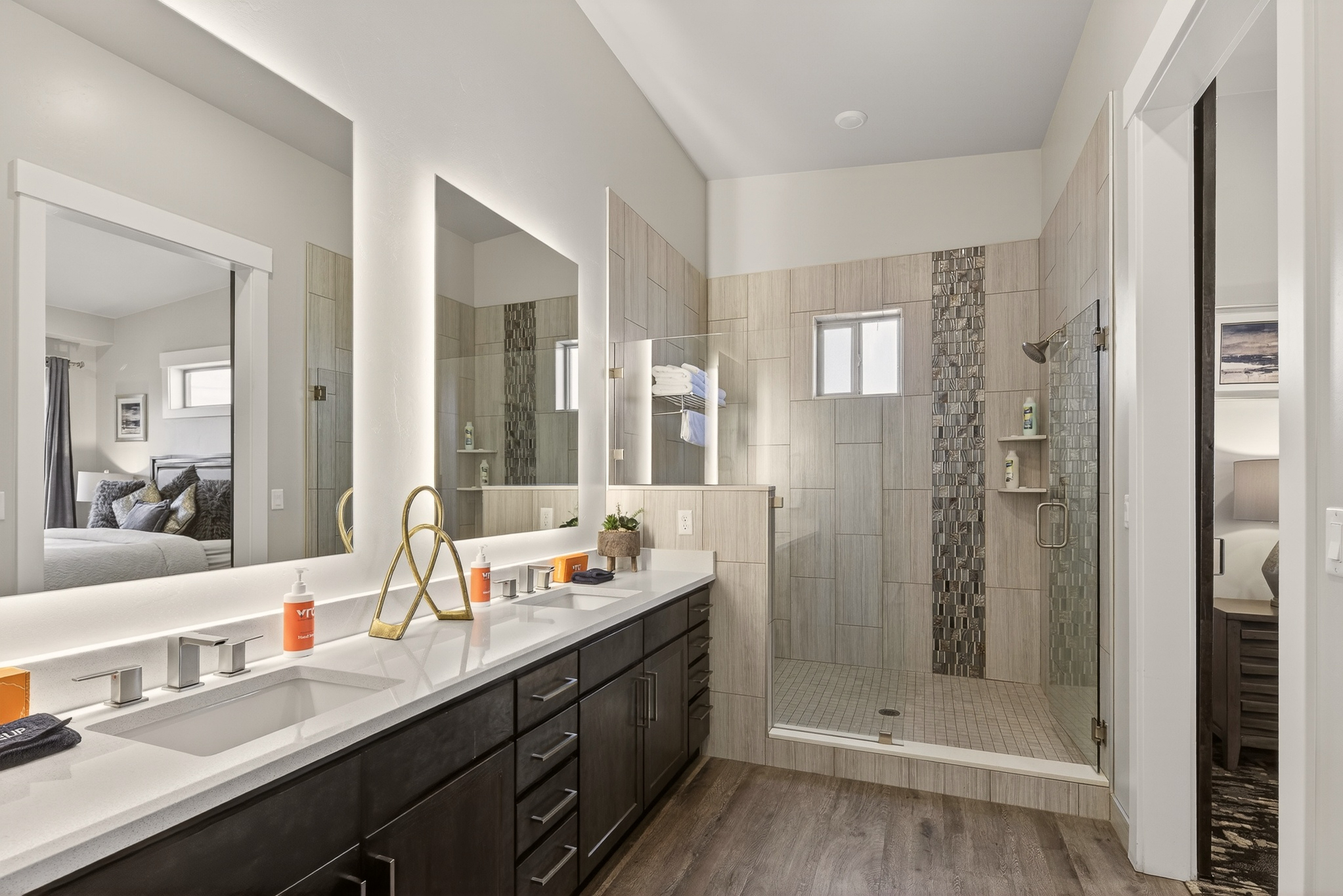Spa-style primary bathroom with double sinks and a spacious walk-in shower.