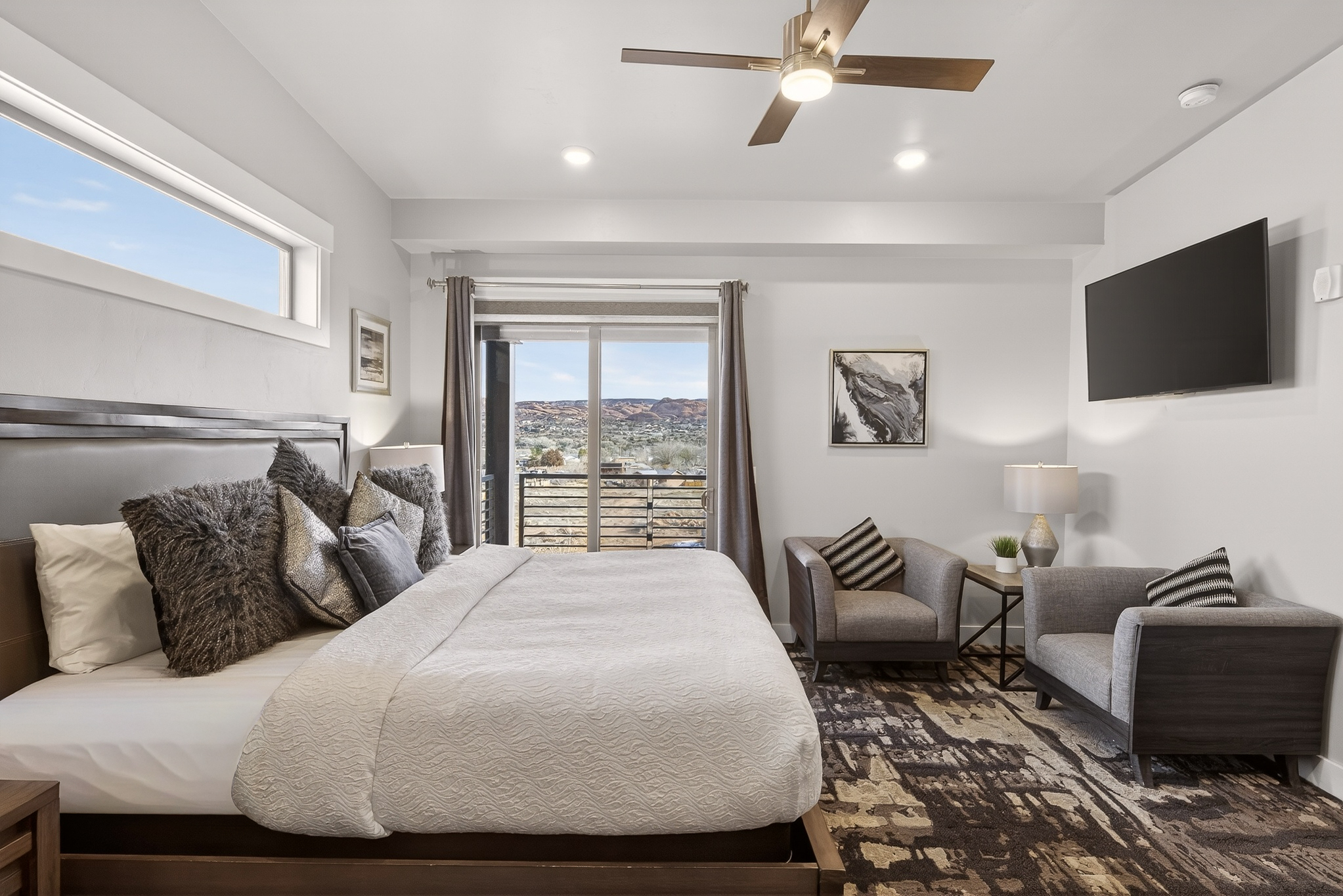 Serene primary bedroom with a plush king bed and private balcony access.