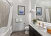 Full bathroom in hallway with convenient tub/shower combo and modern finishes.
