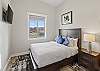 Bright and clean queen bedroom, perfect for a comfortable stay.
