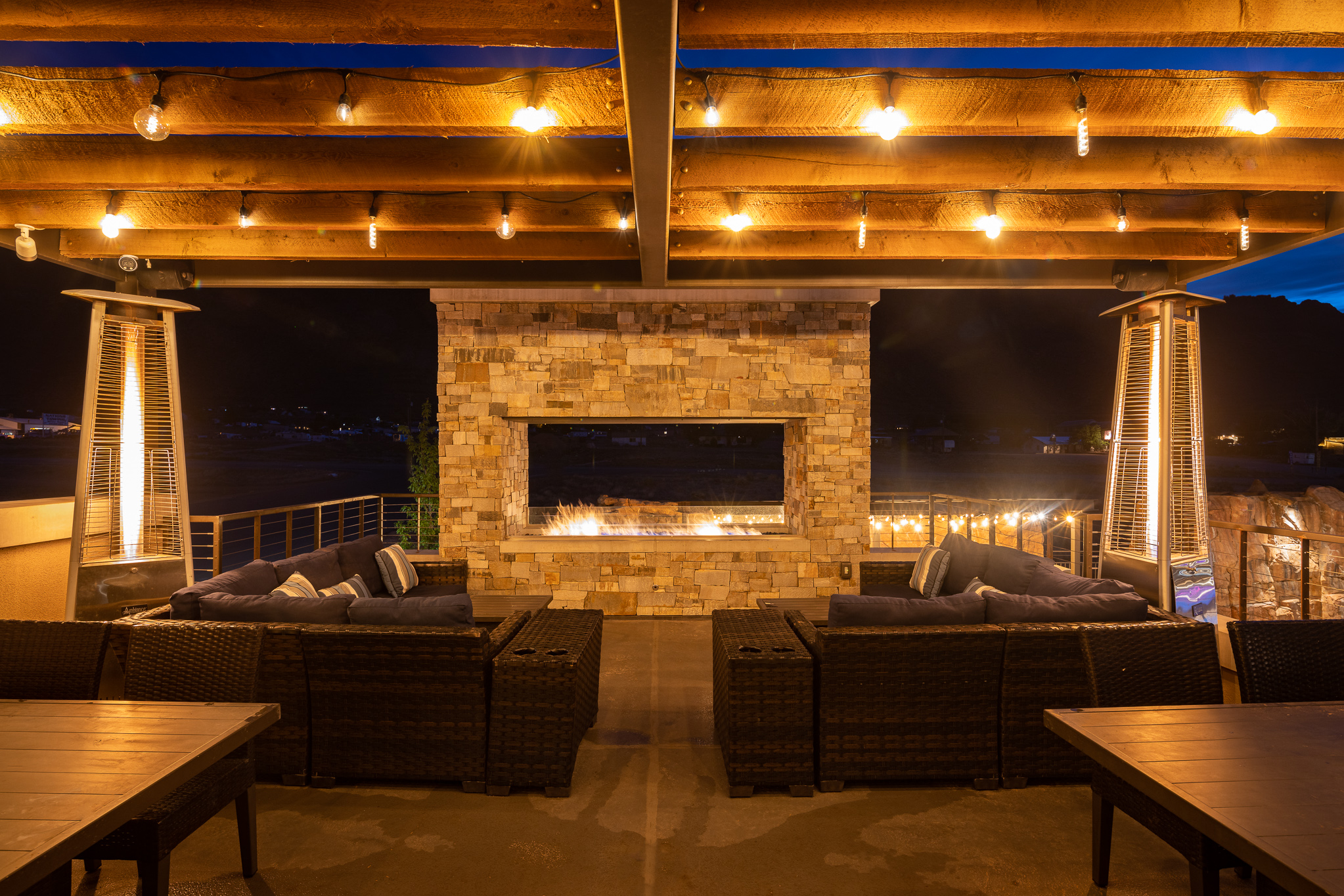 Poolside fire pits and warming kiosks create a cozy gathering spot on cool desert evenings.