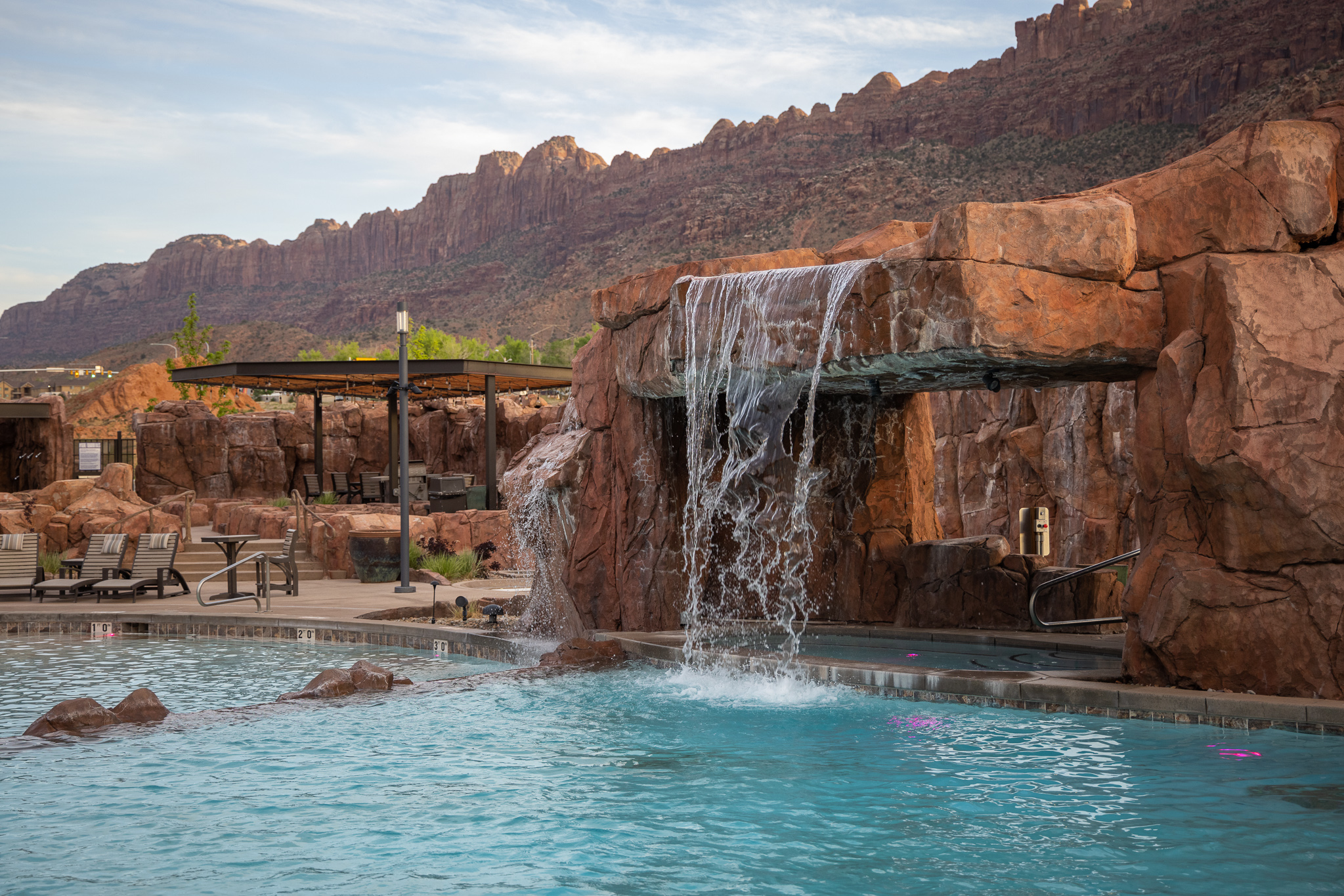 Resort-style oasis at Sage Creek with panoramic red rock cliffs and La Sal Mountain views all around.