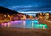 Evening pool scene with dramatic lighting and stunning La Sal Mountain views.