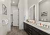 Spa-style primary bathroom with double sinks and a spacious walk-in shower.