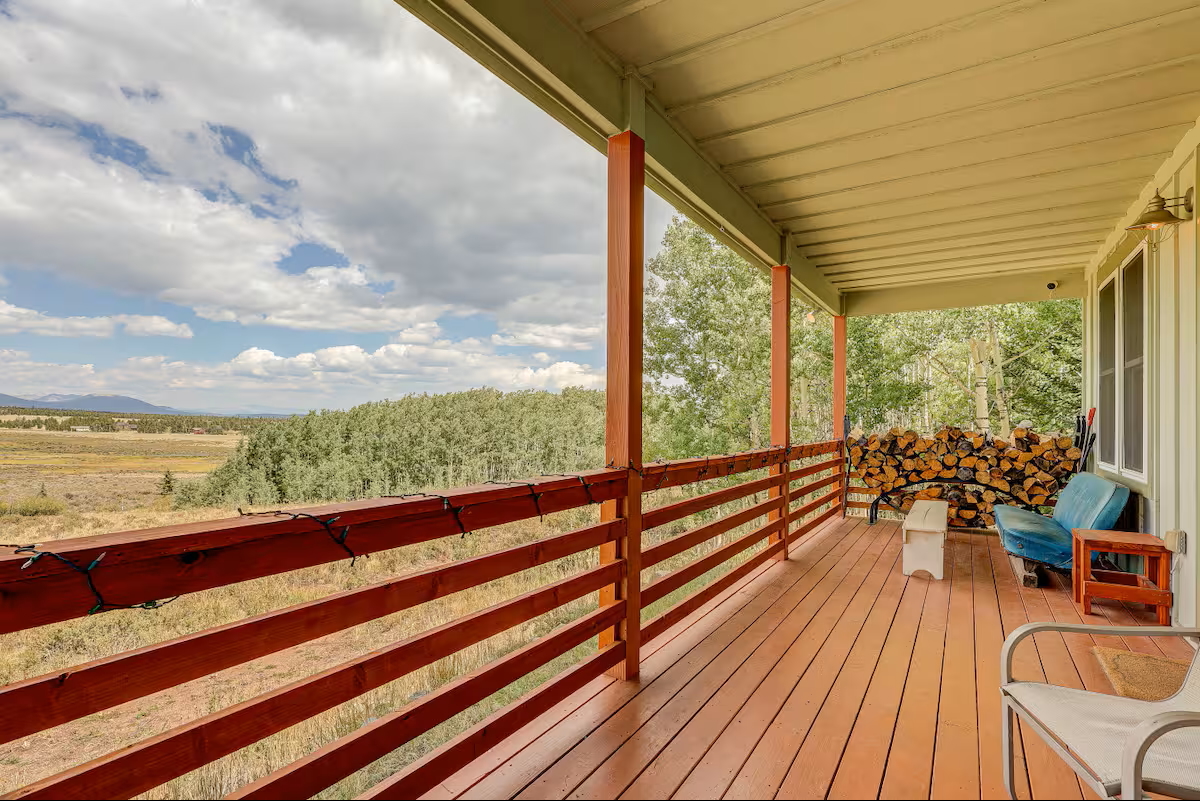 Covered front porch with stunning mountain valley views and comfortable seating - the perfect spot to unwind and take in the Colorado scenery.
