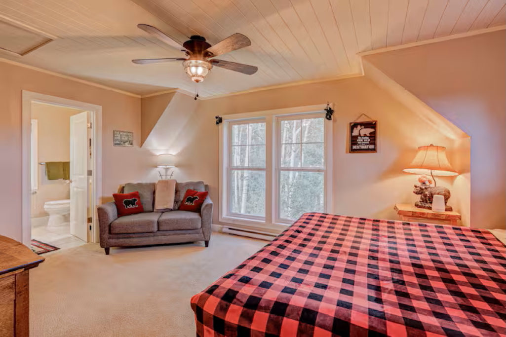 Unwind in this spacious king bedroom #2 with an ensuite bathroom - featuring an overhead fan and large windows